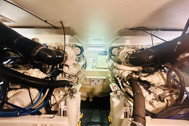 Coming To Fort Lauderdale By Nov. 3 Yacht Photos Pics Engine room of a 1999 Viking Cockpit Sports Yacht, showcasing dual engines and mechanical components.