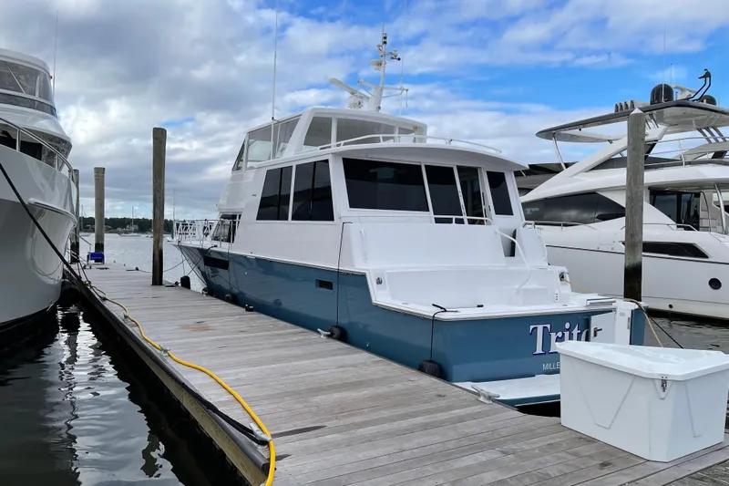 Least Expensive In The World Yacht Photos Pics 1999 Viking Cockpit Sports Yacht docked at marina under cloudy sky.
