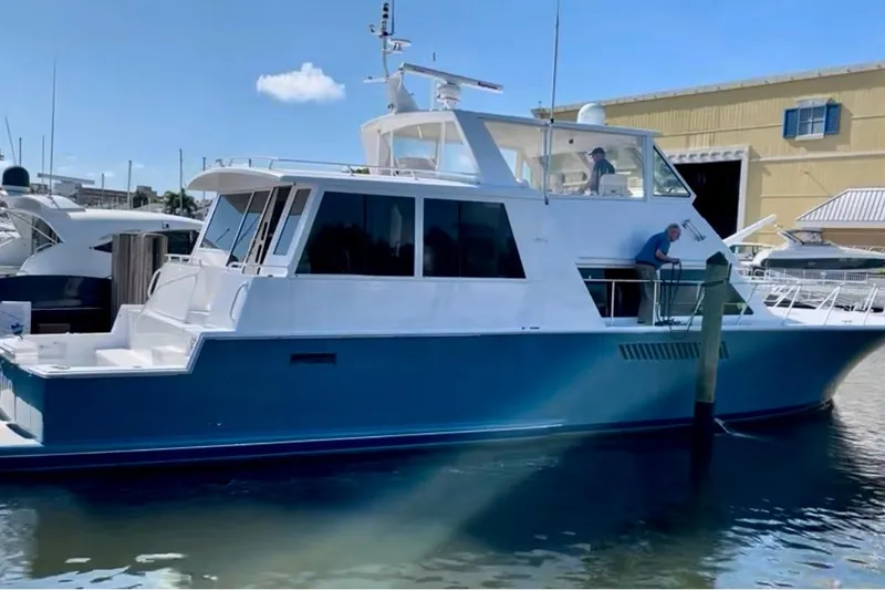 Least Expensive In The World Yacht Photos Pics 1999 Viking Cockpit Sports Yacht docked at marina under clear blue sky.