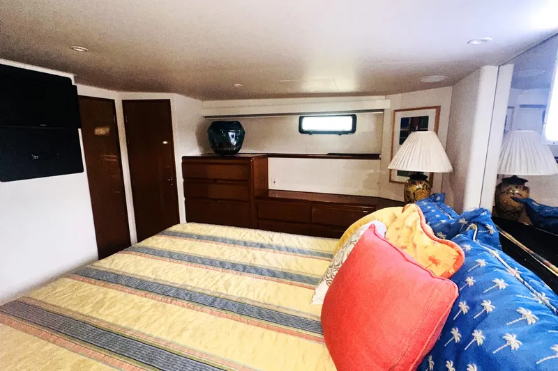 Least Expensive In The World Yacht Photos Pics Luxurious interior of 1999 Viking Cockpit Sports Yacht with cozy bedroom and elegant decor.