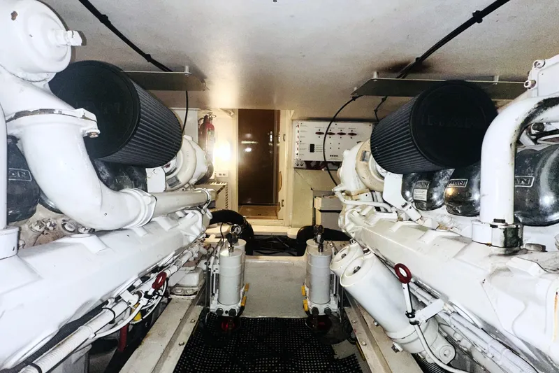Least Expensive In The World Yacht Photos Pics Engine room of a 1999 Viking Cockpit Sports Yacht, showcasing dual engines and mechanical components.