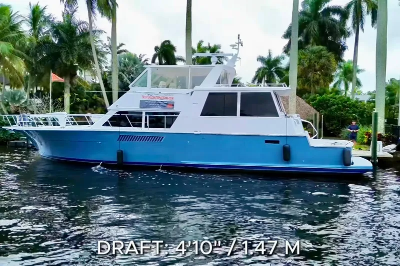 Triton Yacht Photos Pics 1999 Viking Cockpit Sports Yacht on water, surrounded by palm trees, draft 4'10" (1.47 m).