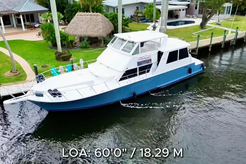 Triton Yacht Photos Pics 1999 Viking Cockpit Sports Yacht, 60-foot length, docked near waterfront homes.