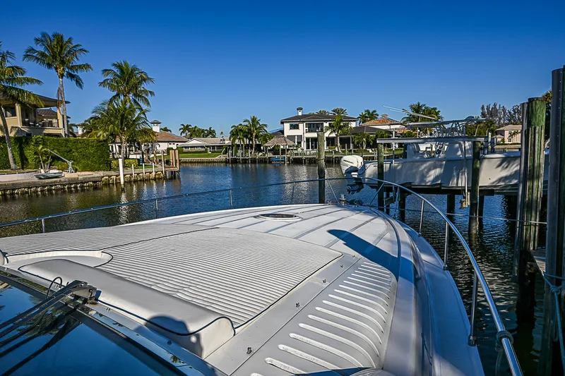  Yacht Photos Pics Luxury Pershing 65 Limited yacht docked in a scenic waterfront area, 2000 model.