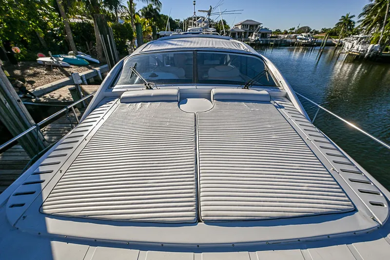  Yacht Photos Pics 2000 Pershing 65 Limited yacht docked in a serene marina setting.