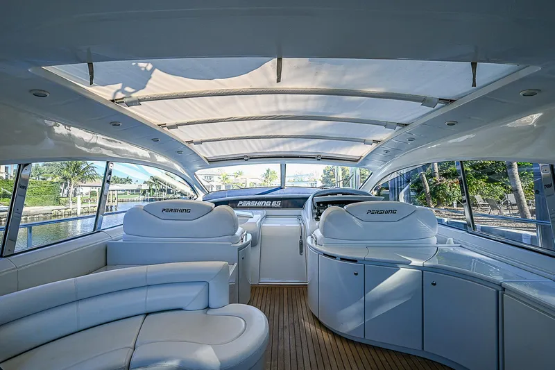  Yacht Photos Pics Luxurious interior of 2000 Pershing 65 Limited yacht with white seating and panoramic windows.