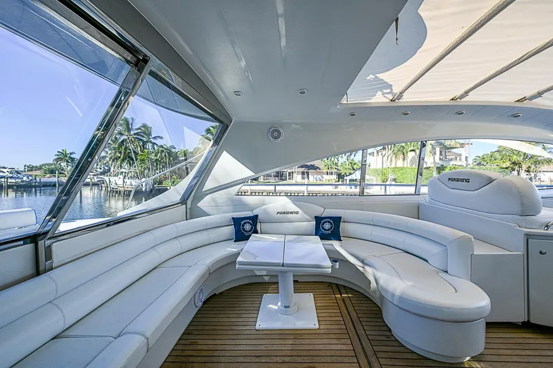  Yacht Photos Pics Luxurious interior of 2000 Pershing 65 Limited yacht with white seating and wooden flooring.