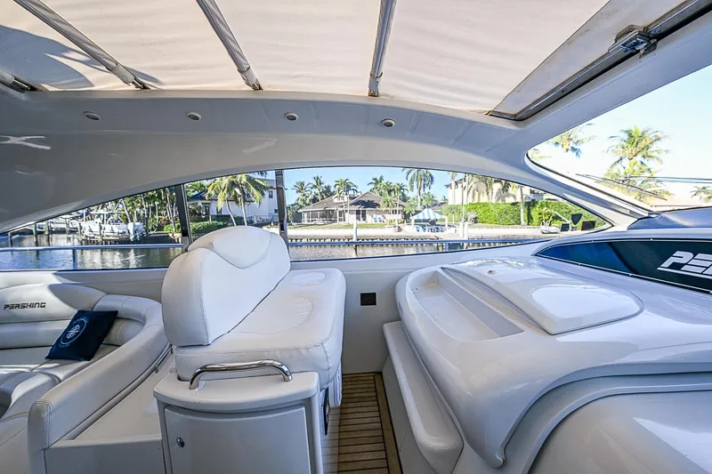  Yacht Photos Pics Interior view of 2000 Pershing 65 Limited yacht with luxurious seating and waterfront backdrop.