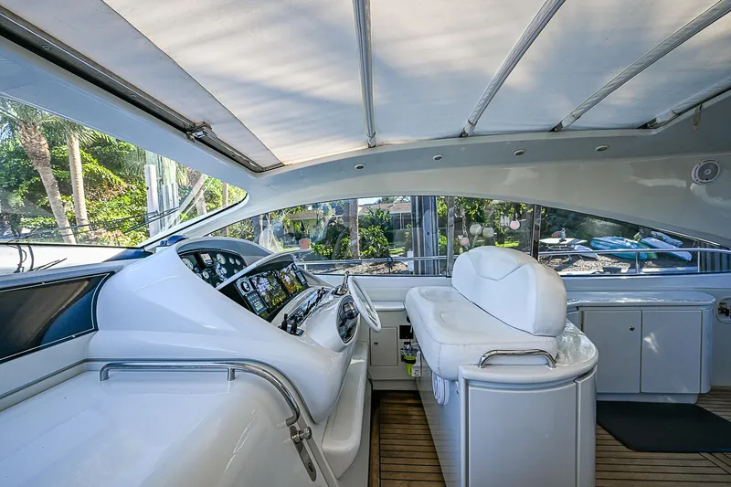  Yacht Photos Pics Interior of 2000 Pershing 65 Limited yacht, featuring sleek white helm and seating.