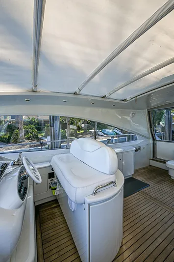  Yacht Photos Pics Interior of 2000 Pershing 65 Limited yacht with sleek white seating and wooden flooring.