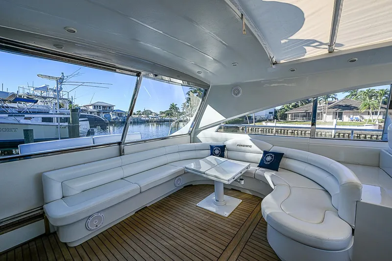  Yacht Photos Pics Luxurious interior of 2000 Pershing 65 Limited yacht with white seating and waterfront view.