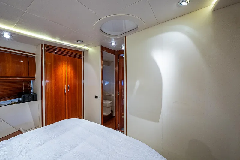  Yacht Photos Pics Luxurious interior of 2000 Pershing 65 Limited yacht cabin with wood accents.