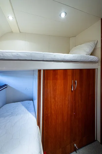  Yacht Photos Pics Interior of 2000 Pershing 65 Limited yacht with bunk beds and wooden cabinetry.