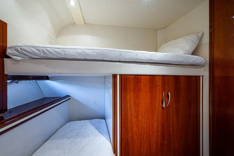  Yacht Photos Pics Bunk beds in 2000 Pershing 65 Limited yacht cabin with wooden cabinets.