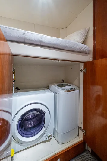  Yacht Photos Pics Laundry area with washer and dryer in Pershing 65 Limited yacht, 2000 model.