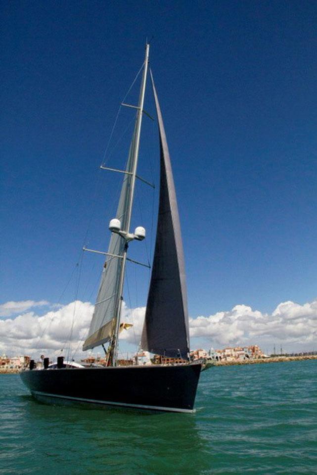 2007 Comar Comet 62 RS sailing yacht on open water under clear blue sky.