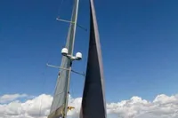 2007 Comar Comet 62 RS sailing yacht on open water under clear blue sky.