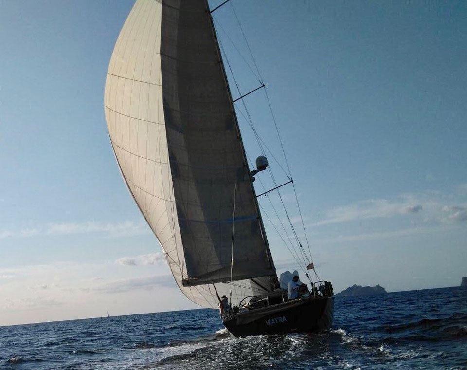 Sailing yacht Comar Comet 62 RS 2007 navigating on open sea under clear skies.