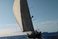 Sailing yacht Comar Comet 62 RS 2007 navigating on open sea under clear skies.