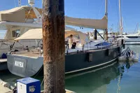 Sailing yacht Comar Comet 62 RS 2007 docked in a marina, sunny day.
