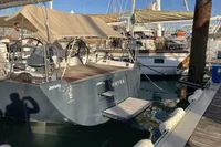 2007 Comar Comet 62 RS yacht docked at marina, featuring sleek design and spacious deck.
