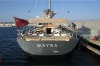 Comar Comet 62 RS yacht, 2007 model, docked with red flag and beige canopy.