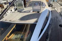 2007 Comar Comet 62 RS yacht with sleek deck and open hatch in marina.
