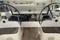 2007 Comar Comet 62 RS yacht cockpit with dual steering wheels and open storage compartment.