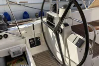Steering wheel of 2007 Comar Comet 62 RS yacht with wooden deck details.