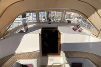 2007 Comar Comet 62 RS yacht cockpit with wooden flooring and beige canopy.