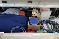 Storage compartment of a 2007 Comar Comet 62 RS yacht filled with various supplies and equipment.