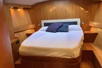 Luxurious cabin interior of 2007 Comar Comet 62 RS yacht with cozy bed.