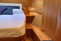 Luxurious wooden interior of 2007 Comar Comet 62 RS yacht cabin.