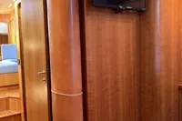 Interior of 2007 Comar Comet 62 RS yacht with wood paneling and mounted TV.
