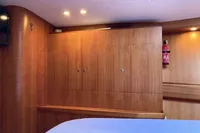 Interior of 2007 Comar Comet 62 RS yacht with wooden cabinetry and fire extinguisher.