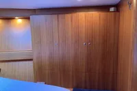 Interior of 2007 Comar Comet 62 RS yacht with wooden cabinetry and soft lighting.