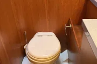 2007 Comar Comet 62 RS yacht bathroom with wooden paneling and modern toilet.