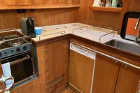 Kitchen area of 2007 Comar Comet 62 RS yacht with stove, sink, and dishwasher.