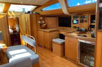 Luxurious interior of 2007 Comar Comet 62 RS yacht with wooden cabinetry and modern amenities.