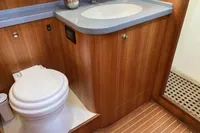 Luxurious bathroom in 2007 Comar Comet 62 RS yacht with wooden cabinetry and modern fixtures.
