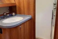 2007 Comar Comet 62 RS yacht bathroom with wooden cabinetry and modern shower.