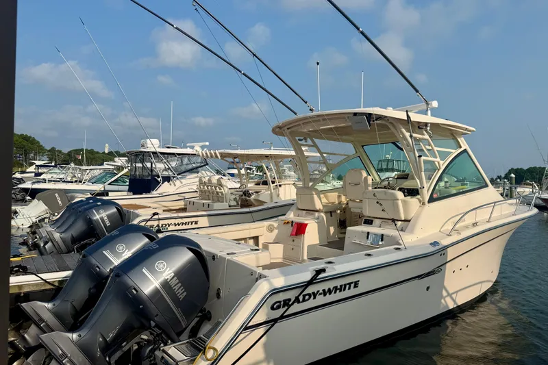  Yacht Photos Pics 2016 Grady-White Express 330 boat docked with Yamaha engines, clear sky background.