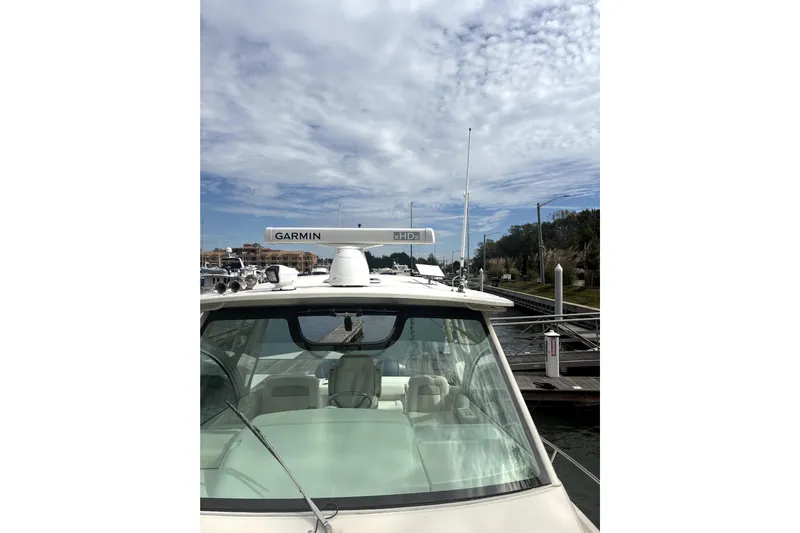  Yacht Photos Pics 2016 Grady-White Express 330 boat docked under a partly cloudy sky.