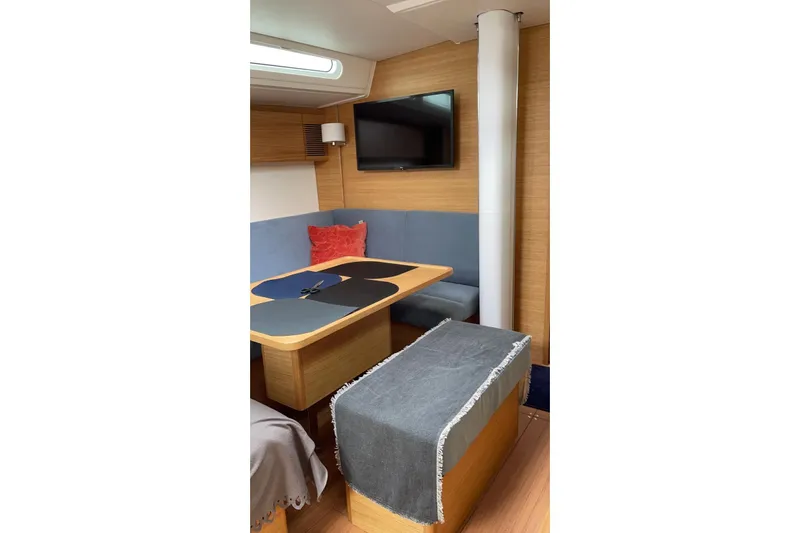 Build No.31 Yacht Photos Pics Interior of 2021 X-Yachts 4.6 featuring a cozy dining area with TV and seating.
