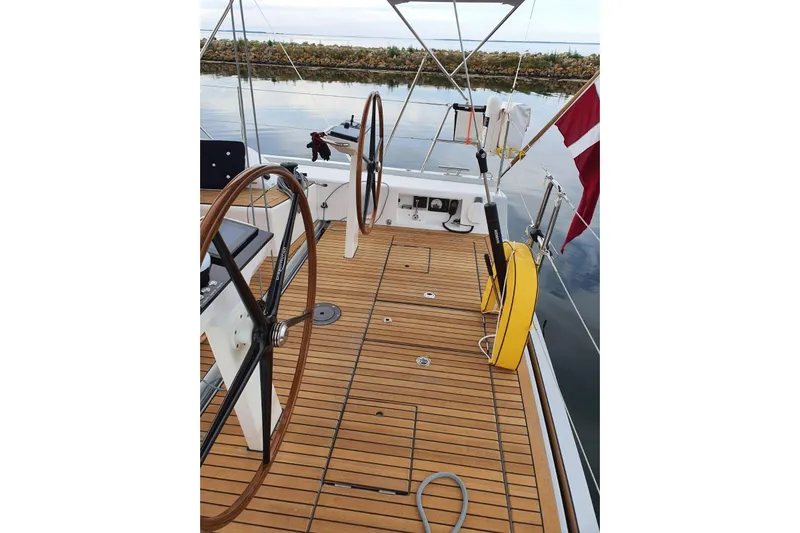 Build No.31 Yacht Photos Pics 2021 X-Yachts 4.6 sailboat deck with dual steering wheels and wooden flooring.