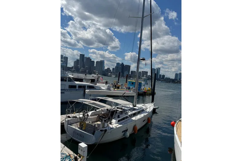 Build No.31 Yacht Photos Pics 2021 X-Yachts 4.6 sailboat docked in a marina with city skyline backdrop.