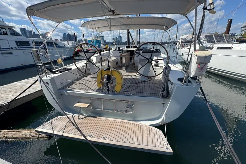 Build No.31 Yacht Photos Pics Sleek 2021 X-Yachts 4.6 sailboat docked, featuring dual steering wheels and spacious deck.