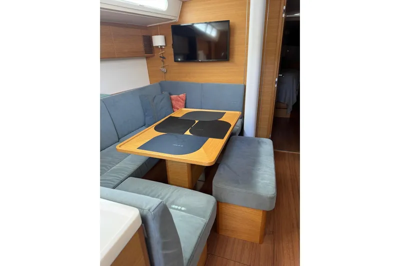 Build No.31 Yacht Photos Pics Interior of 2021 X-Yachts 4.6 featuring a cozy dining area with blue seating.
