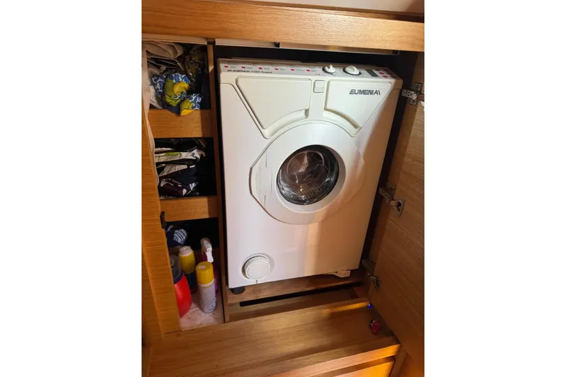 Build No.31 Yacht Photos Pics Compact washing machine in wooden cabinet on 2021 X-Yachts 4.6 sailboat.