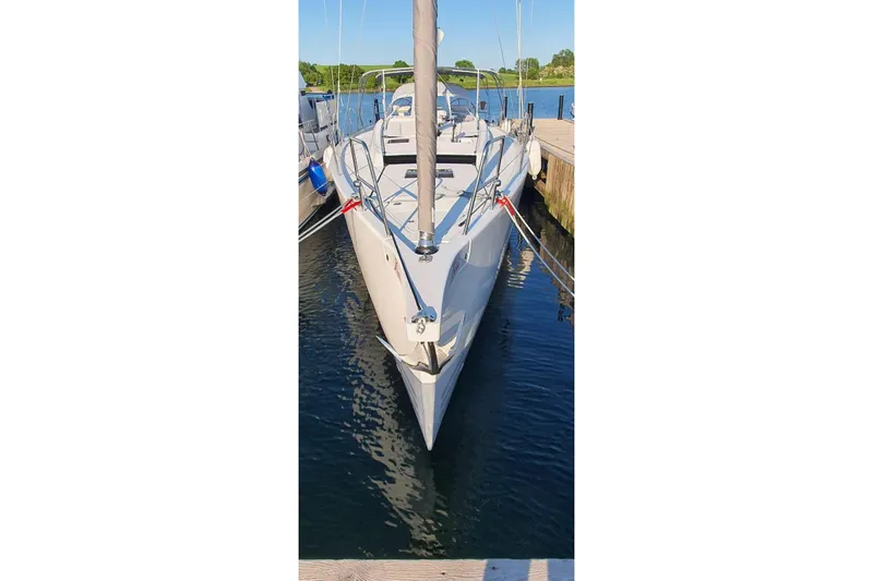 Build No.31 Yacht Photos Pics 2021 X-Yachts 4.6 sailboat docked in a marina, viewed from the bow.